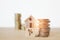 Miniature house on decrease percent icon on wood cube and  stack of coins on wooden desk , for decreasing interest, lower price