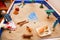 Miniature house, dragon, trees, young girl, senior woman and other toys on a sand box. Sand therapy