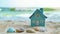 A miniature house on the sand against the backdrop of the sea or ocean. Travel vacation rental concept. Resort property