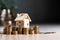 Miniature house wooden model on a stack of coins.