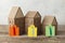 Miniature houses and figures of realtors on a wooden background. Unemployment and crisis