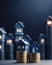 Miniature houses on stacks of coins against a dark backdrop. Symbolizing real estate investment, it portrays financial growth and