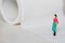 Miniature little people, woman walking in a paper toilet, in a white background