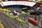 A miniature locomotive depot with railroad tracks, locomotives and buildings..