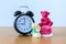 Miniature married couple and teddy bear and clock on wooden. concept for wedding & valentine Day