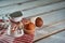 Miniature metal milk jug with tiny cakes on a rustic background