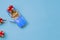 Miniature mini toy.Blue toy car with open top convertible carrying a gift with a red bow on a blue background. View from
