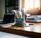 Miniature model of a church on a desk with books and laptop