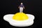 Miniature of an obese man and fried egg