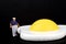 Miniature of an obese man and fried egg