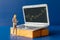 Miniature people, Business people and laptop featuring stock tickers