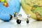 Miniature people : business team, couple of love sitting on airplane wing for travel around the world.