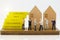 Miniature people: Businessman handshake to business success with wooden houses. Commitment, agreement, investment and partnership