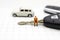 Miniature people : Businessman sitting on car key. Image use for Advertising product in the market today, competition on the