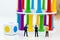 Miniature people: Businessmen stand looking at colorful building. Image use for Construction business