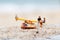 Miniature people: Children play on the swings on the beach with