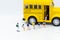 Miniature people : Children,students going to school with school bus. Image use for back to school, education concept