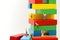 Miniature people : climbing colorful wooden block with challenging route on cliff, Concept of the path to purpose and success.