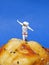 Miniature People concept, close up miniature astronaut standing on muffin, over blue background.