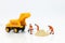 Miniature people: Construction workers building plans , have building materials, sand, brick, mortar. Use image for construction