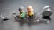 miniature people. a couple of elderly people near a broken hourglass. life time crisis. the concept of the end of life for a