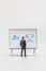 Miniature people, A dejected businessman is positioned in front of a white board, Blue monday concept
