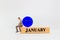 Miniature people, A dejected businessman is sitting on a wooden with Blue face emoji , Blue monday concept