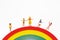 Miniature people: family and children enjoy on rainbow, happy family day concept