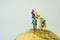 miniature people figure happy family holding balloons standing o