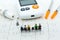 Miniature people and glucose meter with lancet. Image use for medicine, diabetes, health care concept