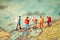 Miniature people: Group of backpacker on vintage world map