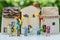 Miniature people with happy family holding balloons with ceramic