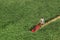 Miniature people: a man is mowing his lawn