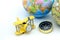 Miniature people : on paddle boat with Compass with world map an