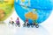 Miniature people : People group riding bicycle with world map. Image use for sport, travel and business concept