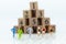 Miniature people running to stack of number wooden block . Image use for healthy , exercise concept