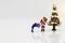 Miniature people: Santa Claus and children with gift
