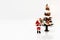 Miniature people: Santa Claus whit Christmas Tree.