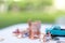 Miniature people sitting on beach sunbath seats and  coins stack.