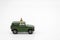Miniature people standing travel planner with Green toy car model as background travel concept with copy space