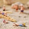 Miniature people in swimsuit on the beach