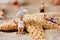 Miniature people in swimsuit on the beach