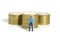 Miniature people toy figure photography. Money protection concept. A security officer standing in front of golden money pile.