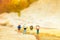 Miniature people: travelers with backpack standing on world map, walking to destination. Image use for travel business concept
