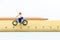 Miniature people: Women cycling on ruler. Image use for travel, business concept