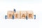 Miniature people worker help building cube wooden block with alphabets combine the word Fear on white background using as greed