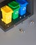Miniature people, workers around three color coded recycle bins, isometric projection with copy-space. Recycling sign on the bins