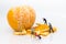 Miniature people : Workers are peeling orange peels. Image use for teamwork, business concept