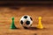 Miniature plastic soccer ball on wooden table