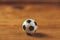 Miniature plastic soccer ball on wooden table